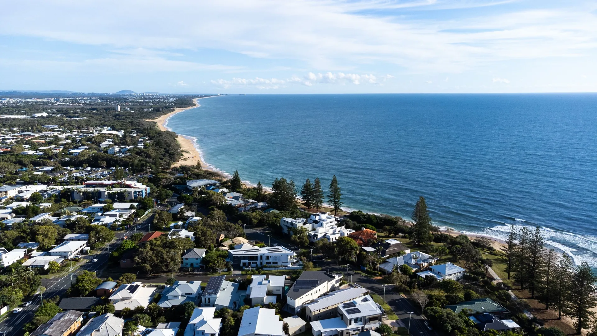 Aerial view along Caloundra coastline and residential areas